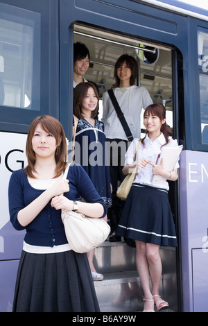 College students getting off the bus Stock Photo
