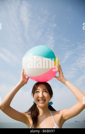Young woman holding with beach ball Stock Photo