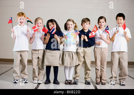 school children waving flags of different countries