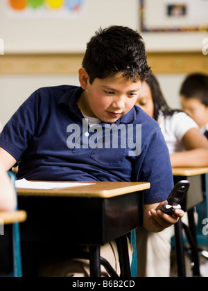 boy texting in school Stock Photo