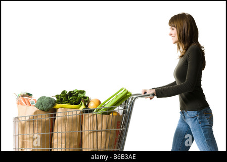 woman pushing a shopping cart Stock Photo