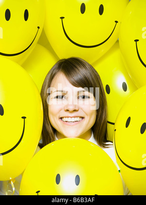 woman with smiley face balloons Stock Photo