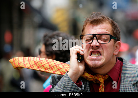 Stressed businessman running down the street. Stock Photo