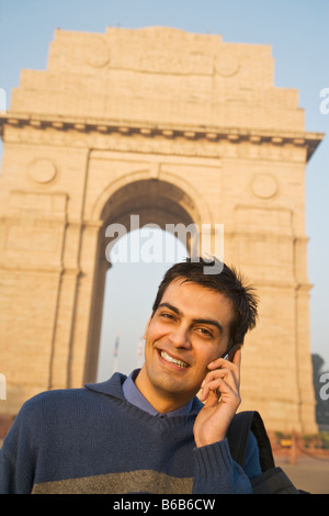 Indian man talking on cell phone near the India Gate Stock Photo