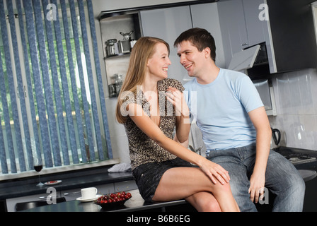 Couple flirting in kitchen Stock Photo