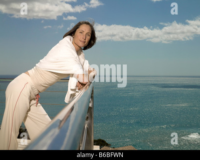 Portrait of woman leaning on railing Stock Photo