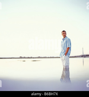 Side profile of man standing in water Stock Photo