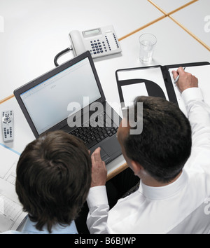 Business executives working on laptop Stock Photo