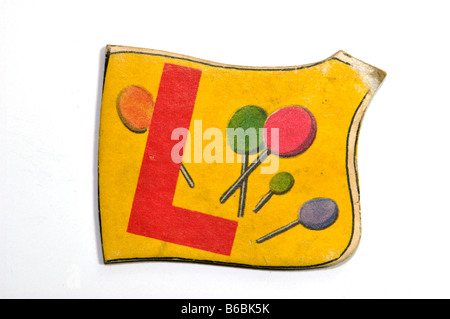 Vintage alphabet letter puzzle piece for children with the letter L and the picture of lollipops printed on it Stock Photo