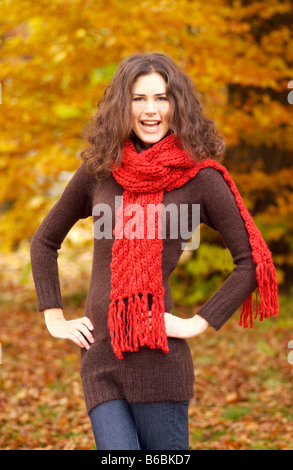 Portrait of woman standing with arms akimbo and smiling Stock Photo