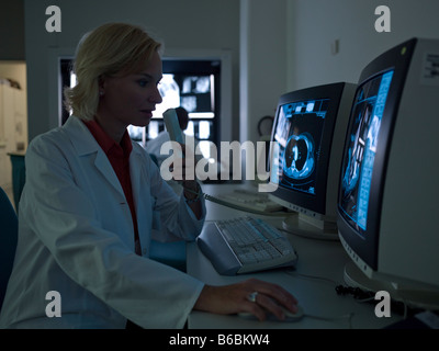 Female doctor examining medical report on computer Stock Photo