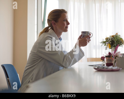 Female doctor drinking coffee Stock Photo