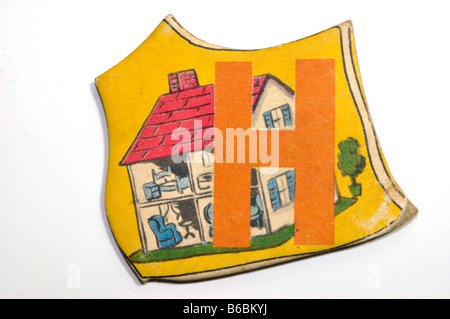 Vintage alphabet letter puzzle piece for children with the letter H and the picture of a house printed on it Stock Photo