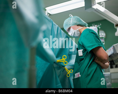 Surgeon standing in operating room Stock Photo