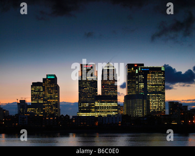 Canary Wharf skyline at sunset shot from across the Thames river dusk London UK Stock Photo