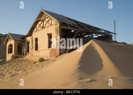 Africa Namibia Kolmanskop Drifting sand dunes fill decaying buildings in ghost town of abandoned diamond mining town Stock Photo