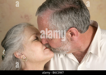 A mature couple sharing a passionate kiss Focus on him Stock Photo