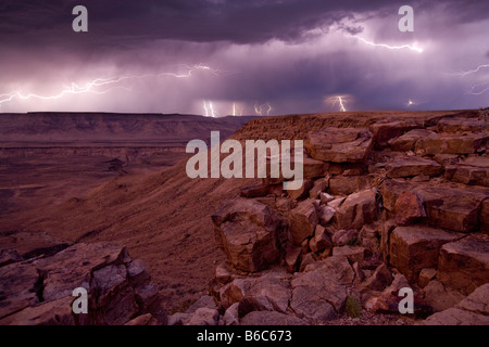 Africa Namibia Fish River Canyon National Park Lightning strikes from storm clouds above walls of Fish River Canyon at dusk Stock Photo