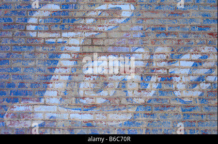 The word LOVE painted in large white script letters on a brick wall Stock Photo