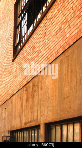 red brick warehouse wall with windows Stock Photo