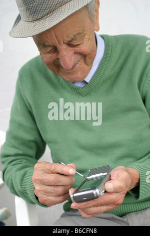 Close-up of senior man using palmtop Stock Photo