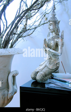 Close-up of praying sculpture on table Stock Photo