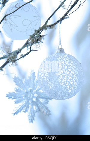 Close-up of Christmas ornaments hanging on tree Stock Photo