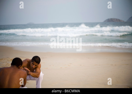 Capoeiristas practice Capoeira on Leblon beach in Rio de Janeiro Brazil Stock Photo