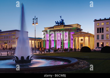 Tourists in front of gate at dusk, Brandenburg Gate, Berlin, Germany Stock Photo