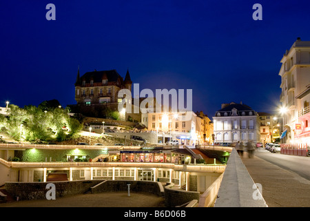 Buildings in city lit up at night, Port Vieux, Biarritz, Pyrenees-Atlantiques, Aquitaine, France Stock Photo