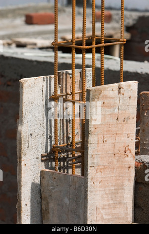 rebars or reinforcing bars from a concrete pillar with blue sky as background. Stock Photo