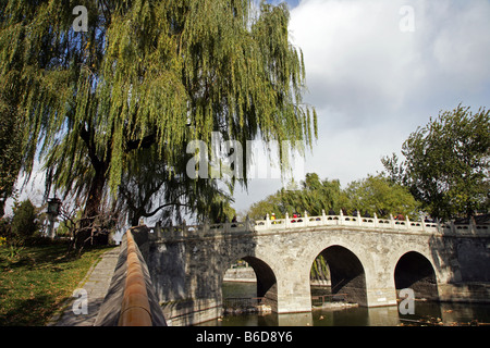 Willow trees and bridge in Beihai Park Beijing China Stock Photo