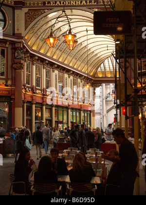 Leadenhall Market covered pub filled street London city UK with name visible in top of image Stock Photo