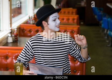 Young man, painted face, mime, smiling Stock Photo