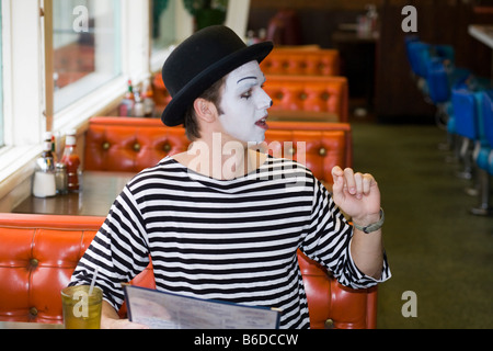 Young man, painted face, mime, smiling Stock Photo