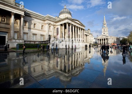 National Gallery and St Martin in the Fields, reflected in puddles. Trafalgar Square, London, England, UK Stock Photo