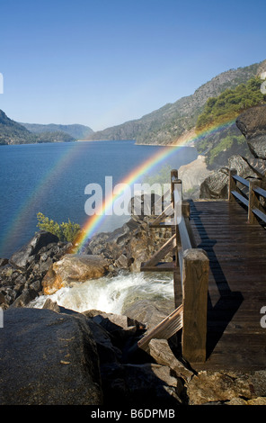 CALIFORNIA Rainbow over the trail at the base of Wapama Falls on the banks of Hetch Hetchy Reservoir in Yosemite National Park Stock Photo