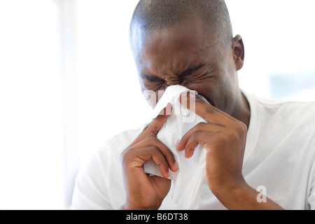 Man sneezing into a handkerchief.