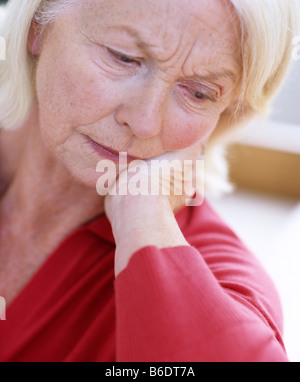 Depressed woman. 63 year old woman looking unhappy. Stock Photo