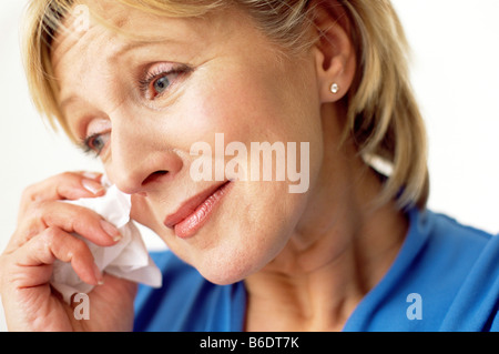 Sad woman, Middle aged woman crying and wiping the tears from her eyes. Stock Photo