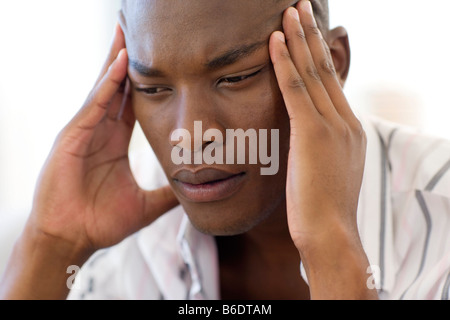 Stress. Unhappy man pressing his fingers to his forehead. Stock Photo