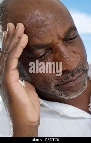 Depression. Unhappy man resting his head on his hand. Stock Photo