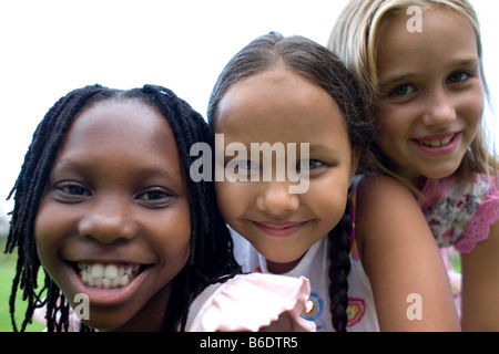 Friendship. Three girls huddled together. Stock Photo