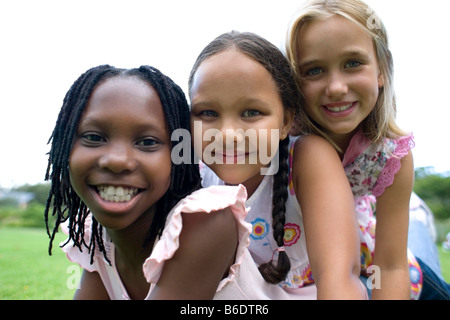 Friendship. Three girls huddled together. Stock Photo