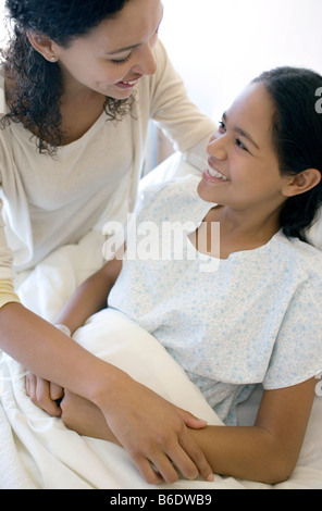 Hospital visit. Mother visiting her teenage daughter on a hospital ward. Stock Photo