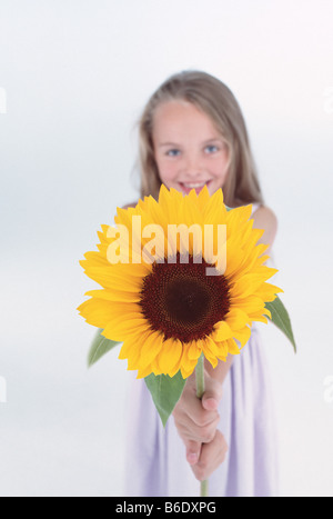 Portrait of girl holding sunflower Stock Photo - Alamy