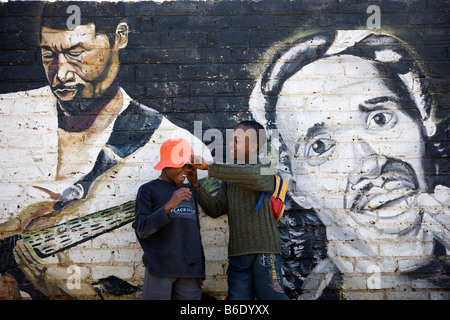 South Africa, Johannesburg, Soweto, Boys in front of murals showing famous artists Stock Photo