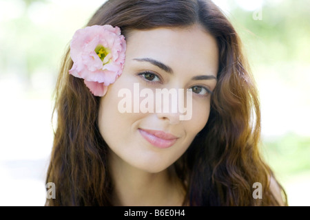Woman wearing a flower in her hair. Stock Photo