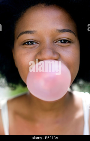 Girl blowing bubblegum. Stock Photo