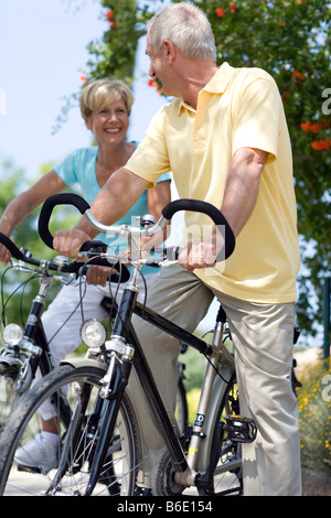 Cyclists. Smiling couple enjoying a cycle ride in the countryside. Stock Photo